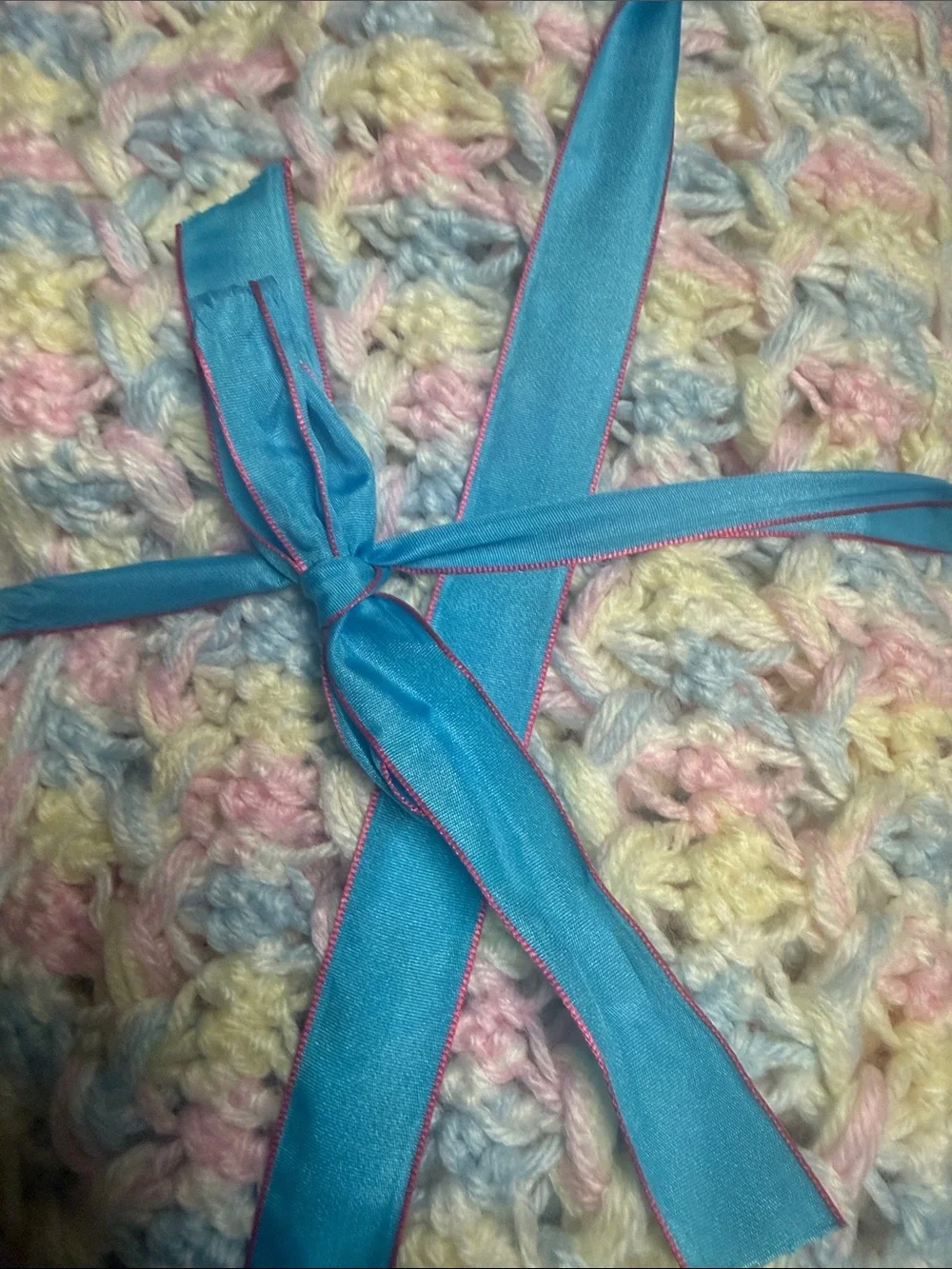 White Crochet Baby Throw with Pastel Pink, Blue, and Yellow Accents